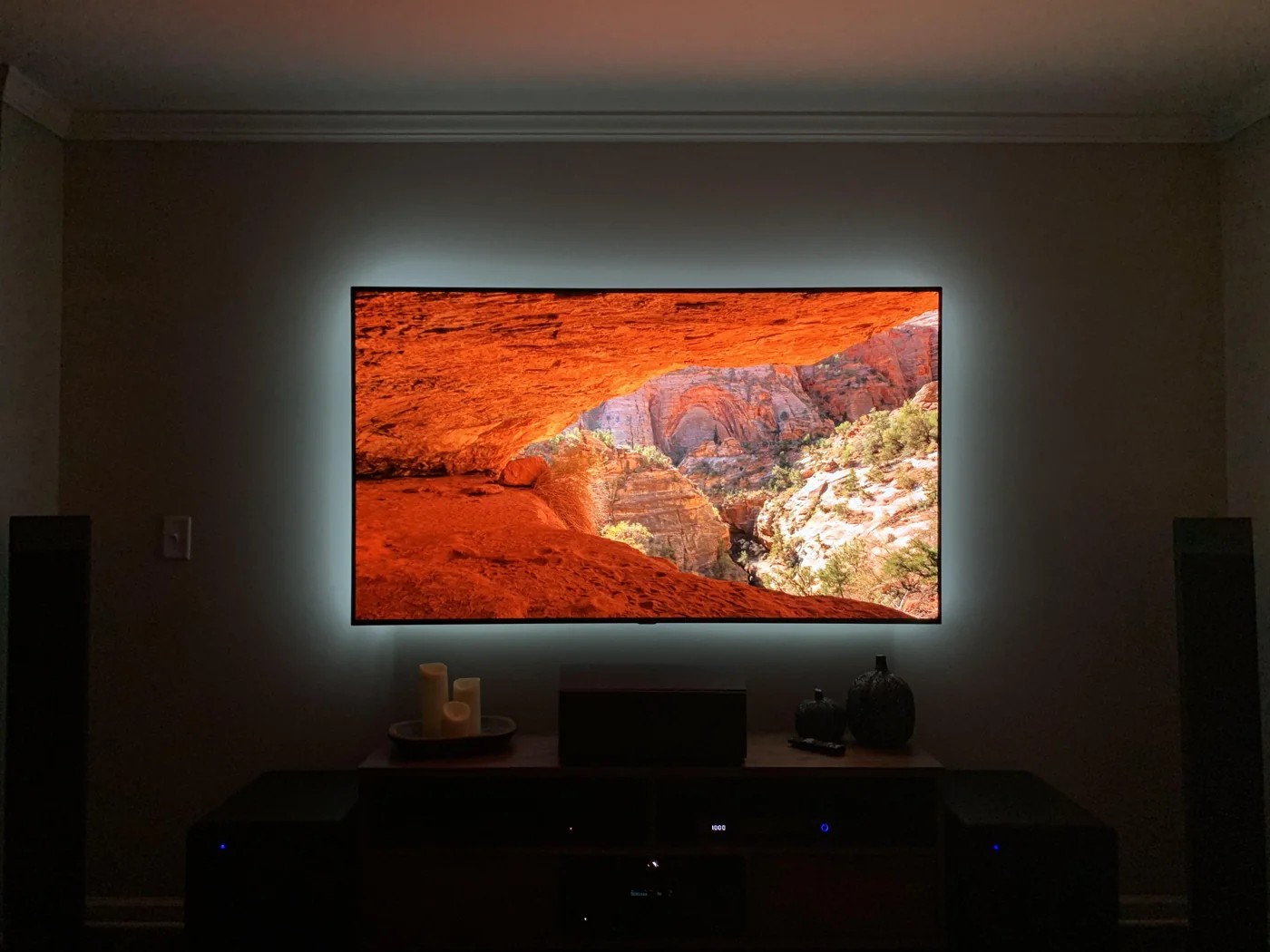 A TV and home audio setup with two floorstanding speakers and a center speaker