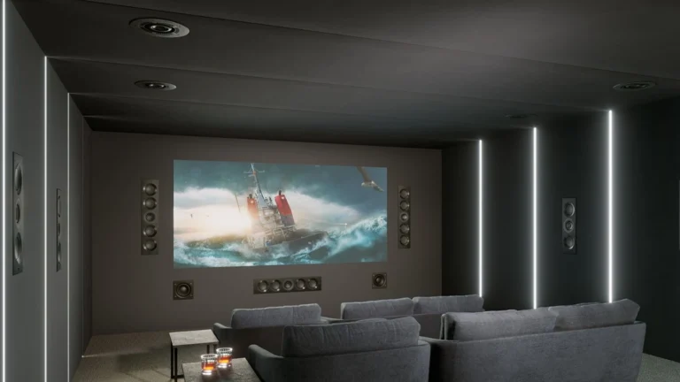 KEF projector theater with a large screen, tiered seating and large architectural speakers