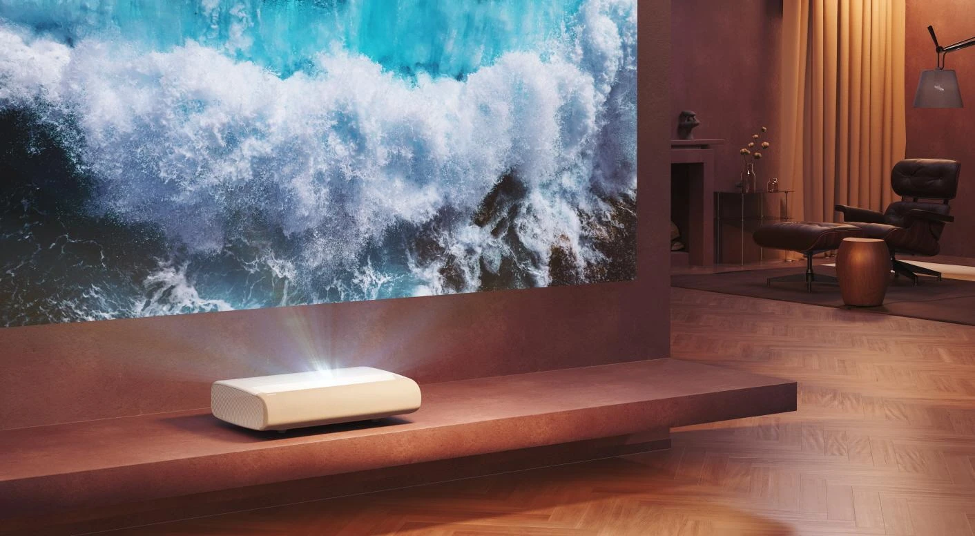 Samsung The Premiere ultra-short-throw projector close to a large screen in a living room