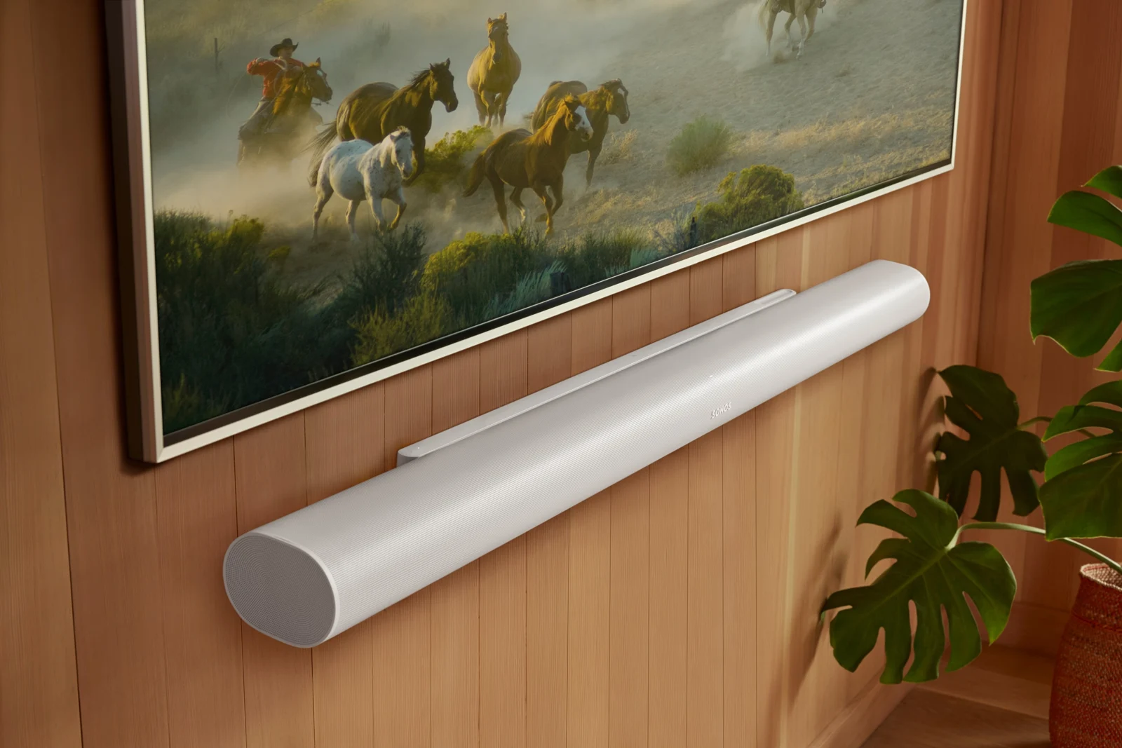 White Sonos Arc Ultra mounted directly below a TV, without visible surround speakers